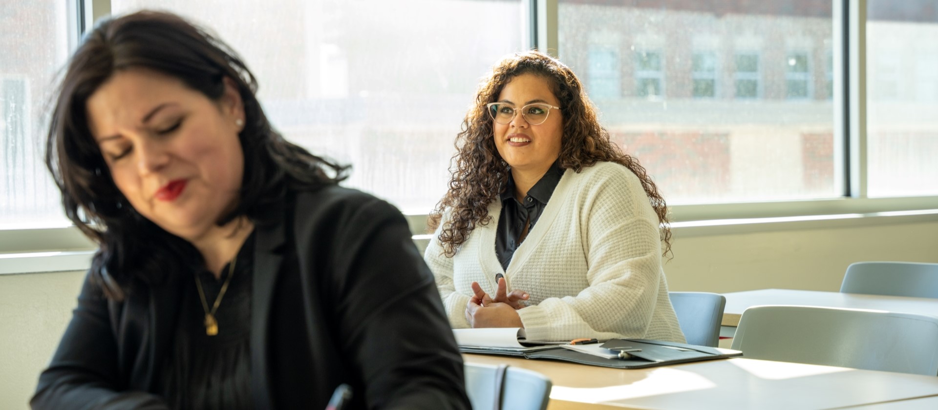 Two students sitting in a classroom.