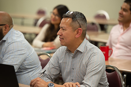 man smiling and paying attention in class