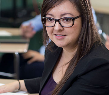 A female student in class talking with a colleague.