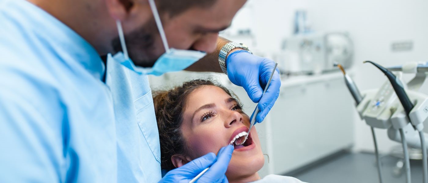 Dental assistant with patient