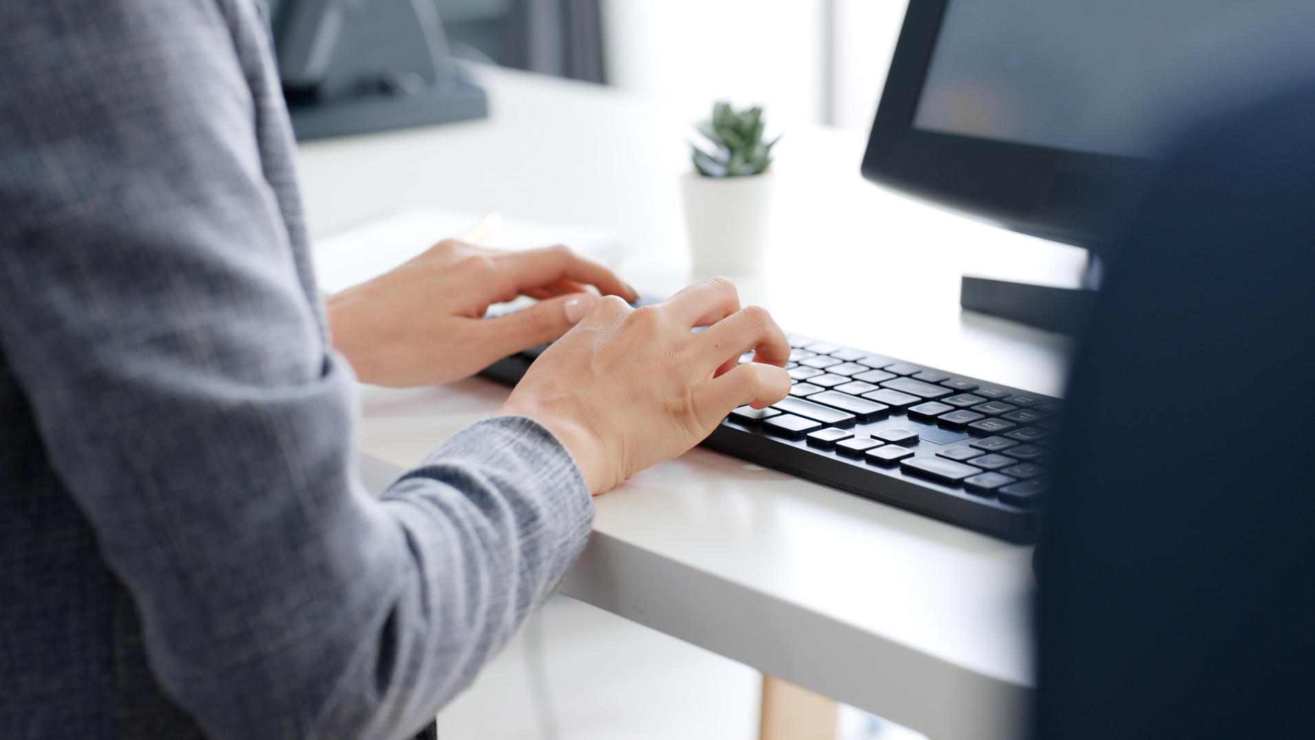 fingers typing on keyboard
