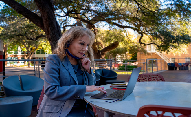 Woman sitting outside using a laptop