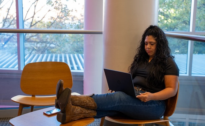 Woman on laptop sitting with feet up