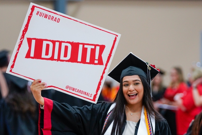 Graduate of the University of the Incarnate Word with sign